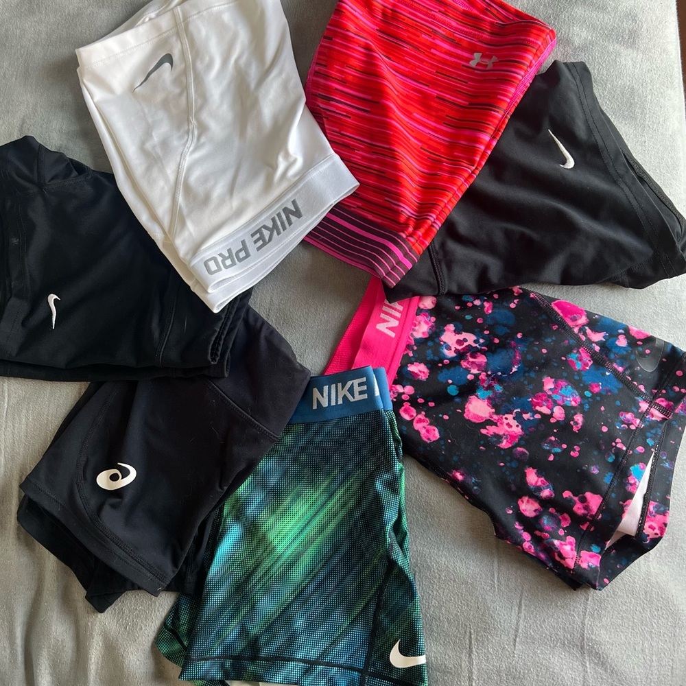 SEVEN pairs of volleyball shorts, size S and Med. NIKE, Under Armor, and ASICS.